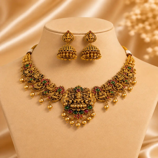 Antique Lakshmi temple jewelry necklace set with traditional jhumka earrings, ruby and emerald stones, and pearl danglings in South Indian bridal style