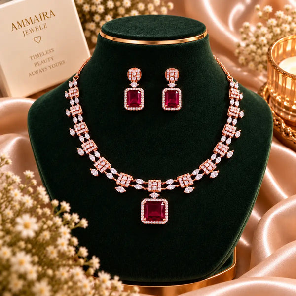 Rose gold Cubic Zirconia necklace set with matching dangling earrings, featuring a linked necklace design, sparkling rectangular centre stones and an elegant statement pendant.