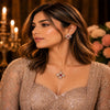 Rose gold Cubic Zirconia pendant set with matching floral-inspired earrings, red centre stones, sparkling clear CZ accents and elegant four-petal design by Ammaira Jewelz.