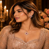 Rose gold Cubic Zirconia pendant set with matching floral-inspired earrings, red centre stones, sparkling clear CZ accents and elegant four-petal design by Ammaira Jewelz.