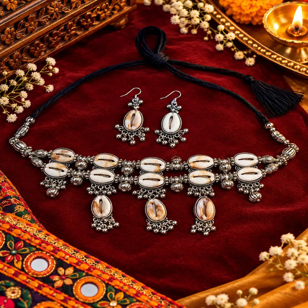 Cowrie shell oxidised necklace set with matching earrings and intricate silver detailing for women