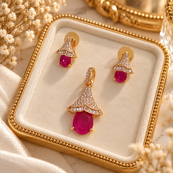 Rose gold American diamond pendant set featuring a ruby-red oval centre stone, sparkling fan-shaped detailing and matching drop earrings.