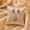Emerald Élan American Diamond pendant set with emerald green rectangular stones, matching earrings, and sparkling halo detailing in gold polish.