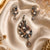 Luxury peacock pearl pendant set with American diamonds and matching designer earrings in black rhodium and rose gold finish.