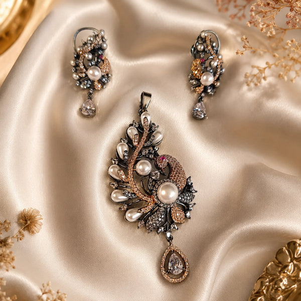 Luxury peacock pearl pendant set with American diamonds and matching designer earrings in black rhodium and rose gold finish.
