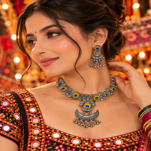 Peacock motif oxidised necklace set with colourful circular motifs, ornate silver detailing and matching earrings