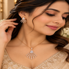 Rose gold American diamond pendant set in premium brass featuring a pear-shaped centre stone, sparkling fan-shaped bars and matching earrings.
