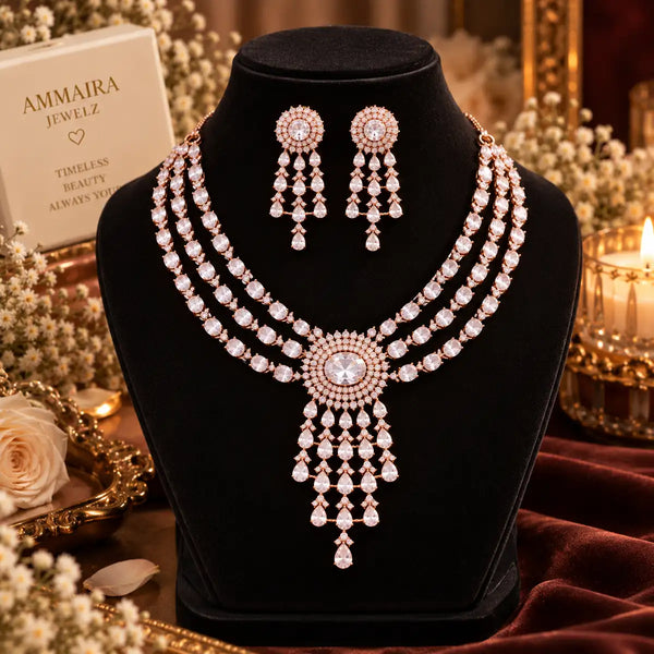 Three-layer Rose Gold Cubic Zirconia necklace set with matching dangling earrings, featuring an oval halo centrepiece and cascading teardrop stone pendant.