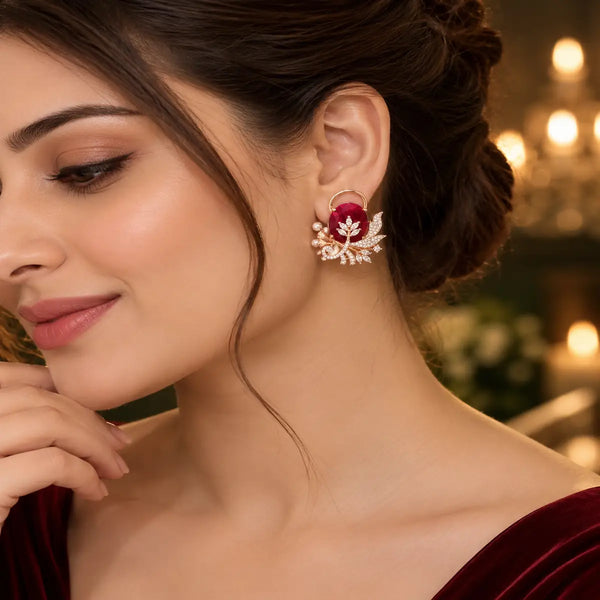 Rose gold floral statement earrings with oval centre stones, leaf motifs and sparkling zirconia detailing, available in ruby red, emerald green, blush pink and deep purple.