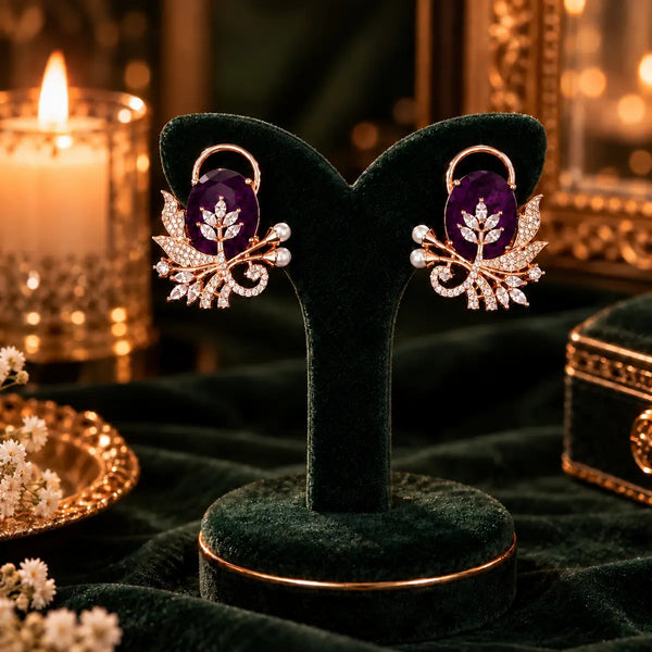 Rose gold floral statement earrings with oval centre stones, leaf motifs and sparkling zirconia detailing, available in ruby red, emerald green, blush pink and deep purple.