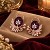 Rose gold floral statement earrings with oval centre stones, leaf motifs and sparkling zirconia detailing, available in ruby red, emerald green, blush pink and deep purple.