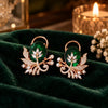 Rose gold floral statement earrings with oval centre stones, leaf motifs and sparkling zirconia detailing, available in ruby red, emerald green, blush pink and deep purple.