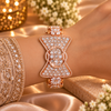 18K rose gold polished premium brass bracelet featuring a bow-inspired design with densely set clear zirconia stones and intricate sparkling borders.