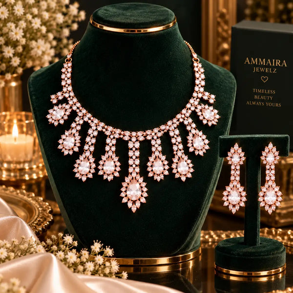 Rose gold Cubic Zirconia floral necklace set with matching dangling earrings featuring pear-shaped stones and cascading sparkle.