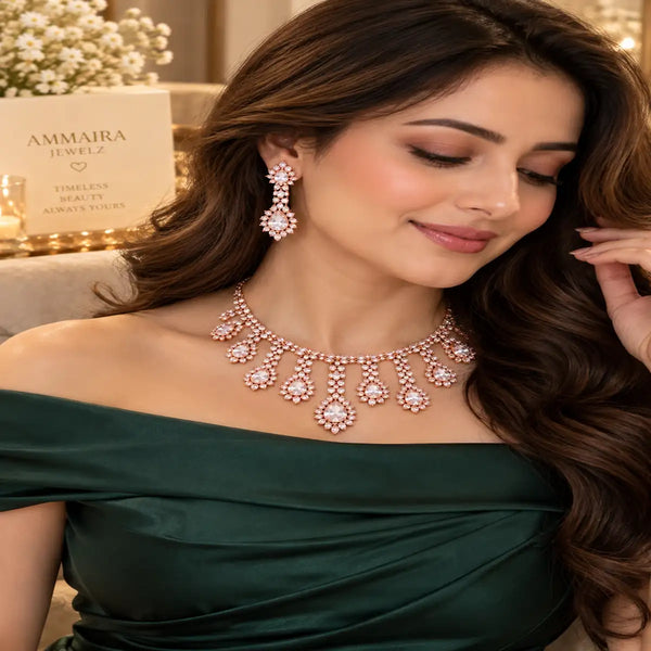 Rose gold Cubic Zirconia floral necklace set with matching dangling earrings featuring pear-shaped stones and cascading sparkle.