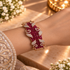 18K rose gold polished premium brass bracelet featuring deep red zirconia stones, clear stone accents and intricate scrollwork detailing.
