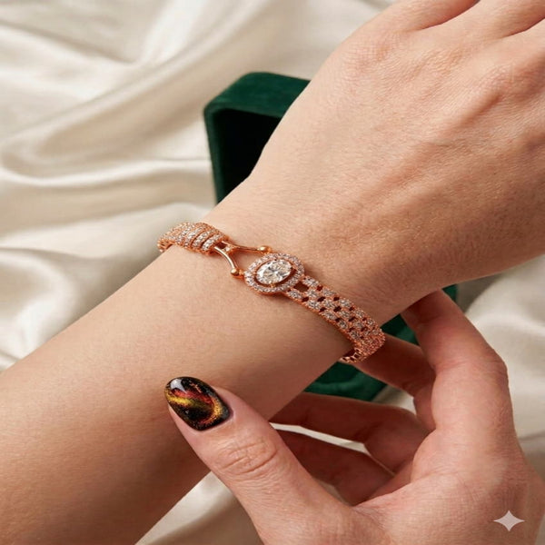 Rose gold bracelet on a wrist with a neutral background