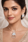 Woman wearing a necklace and earrings with a soft background
