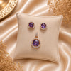 Royal Amethyst Halo American Diamond pendant set with rose gold polish and matching earrings featuring a round purple centre stone.