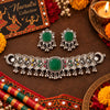 Antique silver-tone oxidized statement choker necklace set for women with green centerpiece, ghungroo drops and matching earrings.