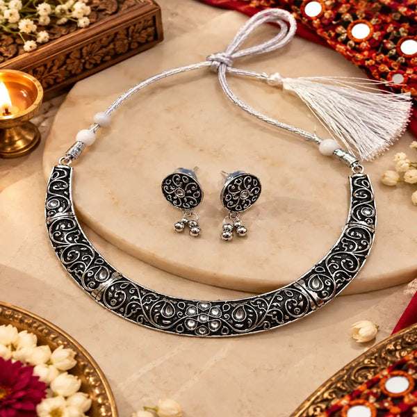 Scrollwork oxidised silver necklace set with intricate ornamental detailing and matching earrings