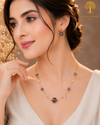 Elegant gold polish mala set with smoky grey and iridescent crystal beads paired with matching crystal earrings displayed on a model and luxury jewelry stand.
