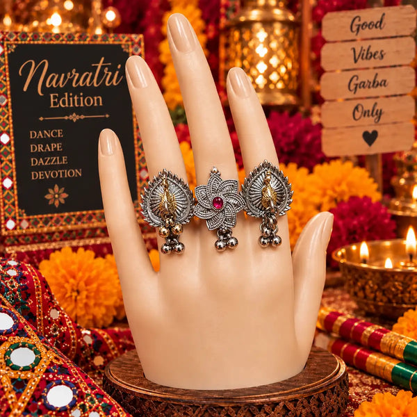 Two-tone fusion oxidised three-finger statement ring featuring peacock and floral motifs with ghungroo accents.