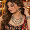 Antique two-tone cowrie shell Navratri necklace set with layered silver-tone beads and matching earrings for women.