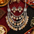Antique two-tone cowrie shell Navratri necklace set with layered silver-tone beads and matching earrings for women.