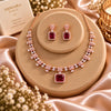Rose gold Cubic Zirconia necklace set with matching dangling earrings, featuring a linked necklace design, sparkling rectangular centre stones and an elegant statement pendant.