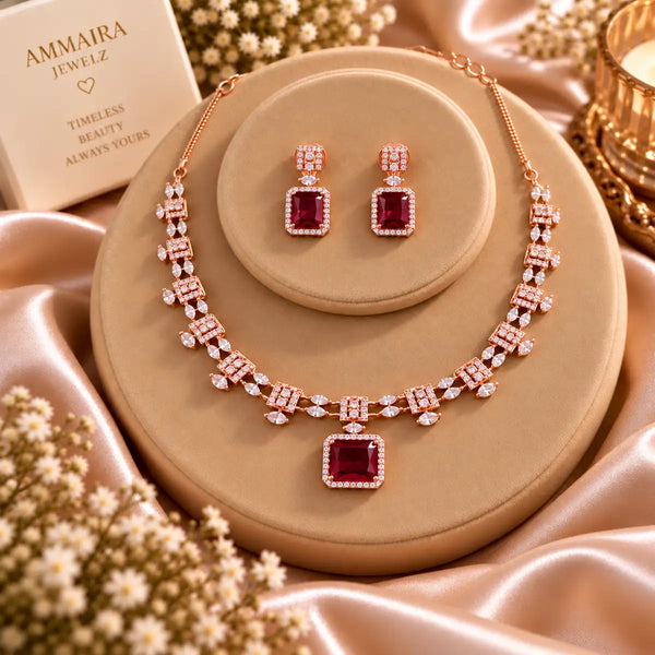 Rose gold Cubic Zirconia necklace set with matching dangling earrings, featuring a linked necklace design, sparkling rectangular centre stones and an elegant statement pendant.