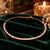 Rose gold Premium Brass hasli necklace featuring alternating rectangular baguette-style stones and sparkling zirconia accents.