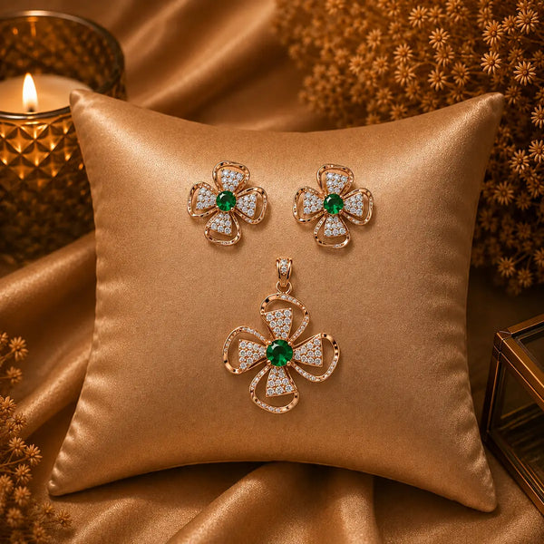 Rose gold Cubic Zirconia pendant set with matching floral-inspired earrings, green centre stones, sparkling clear CZ accents and elegant four-petal design by Ammaira Jewelz.