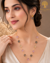 Elegant gold polish mala set with blush pink, smoky grey, and champagne crystal beads paired with matching designer earrings displayed on a model and luxury jewelry stand.