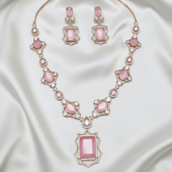 Rose gold necklace set with blush pink oval and rectangular stones, diamond-inspired detailing, and matching drop earrings, displayed on a satin background, showcasing elegant bridal jewellery design.