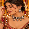 Cowrie shell oxidised necklace set with matching earrings and intricate silver detailing for women