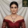 Rose gold necklace set with ruby-red oval and emerald-cut stones, diamond-inspired detailing, and matching earrings, displayed on a satin background, showcasing luxurious bridal jewellery design.
