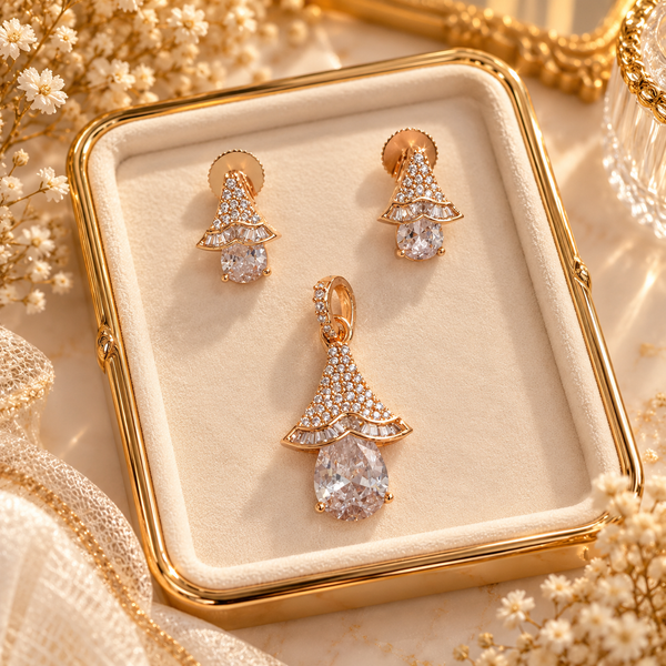 Rose gold American diamond pendant set featuring a ruby-red oval centre stone, sparkling fan-shaped detailing and matching drop earrings.