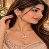 Rose gold American diamond pendant set featuring an angular open lattice design, square clear centre stones and matching geometric earrings.