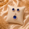 Imperial sapphire blue halo pendant with matching American diamond stud earrings in premium gold-tone finish, pendant set without chain.