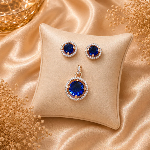 Imperial sapphire blue halo pendant with matching American diamond stud earrings in premium gold-tone finish, pendant set without chain.