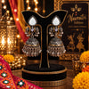 Two-tone oxidized mirror-work jhumka earrings for women featuring teardrop-shaped mirror accents, intricate traditional detailing and festive Navratri styling.