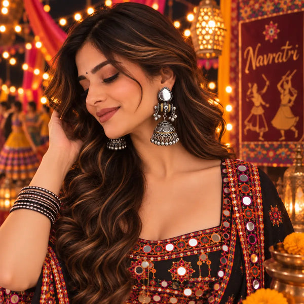 Two-tone oxidized mirror-work jhumka earrings for women featuring teardrop-shaped mirror accents, intricate traditional detailing and festive Navratri styling.