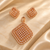 Rose gold American diamond pendant set in premium brass featuring a sparkling square grid design, layered stone borders and matching earrings.