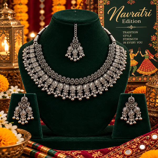 Handcrafted silver oxidised choker necklace set for women featuring layered floral motifs, matching earrings, and maangtikka.
