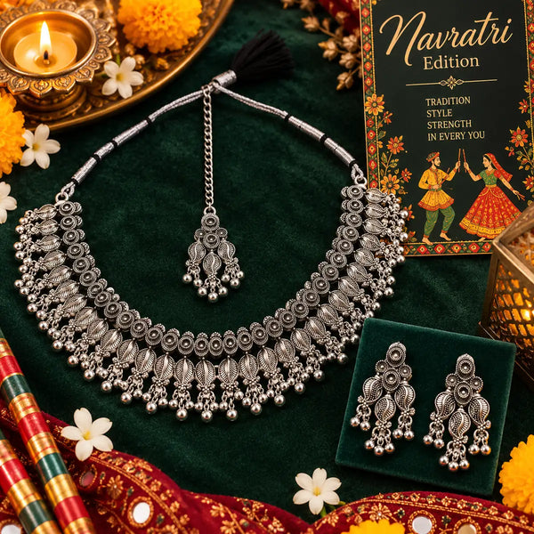 Handcrafted silver oxidised choker necklace set for women featuring layered floral motifs, matching earrings, and maangtikka.