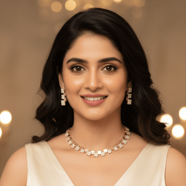 Modern rose gold necklace set with alternating square geometric motifs and matching stud earrings, displayed on a satin background, showcasing minimal luxury jewellery design.