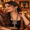 Statement two tone silver and gold oxidized necklace with peacock-inspired pendant, jhumka drop and matching long jhumka earrings for women.