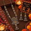Statement two tone silver and gold oxidized necklace with peacock-inspired pendant, jhumka drop and matching long jhumka earrings for women.