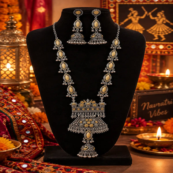 Statement two tone silver and gold oxidized necklace with peacock-inspired pendant, jhumka drop and matching long jhumka earrings for women.